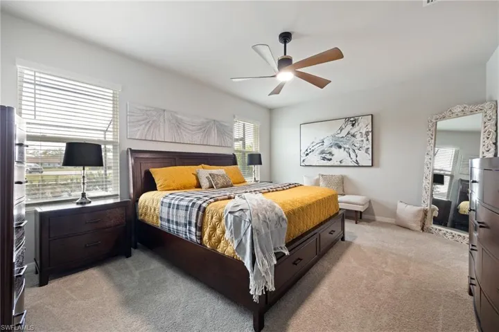 Bedroom featuring light colored carpet and ceiling fan