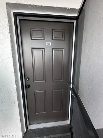 View of exterior entry featuring stucco siding