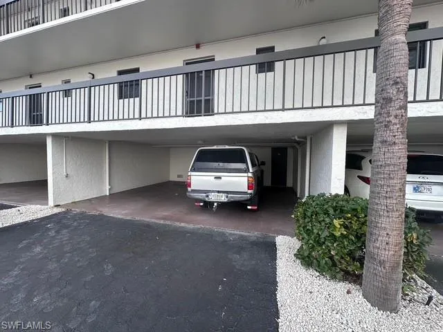 View of car parking featuring a carport