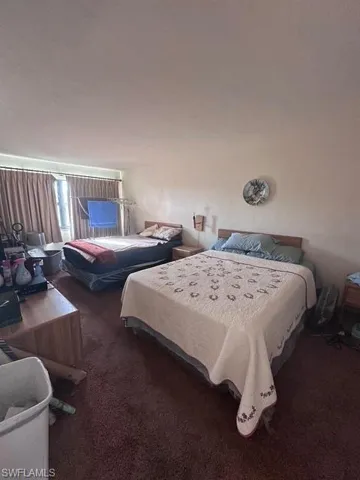 Bedroom with dark carpet