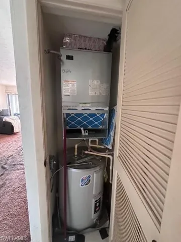 Utility room featuring electric water heater