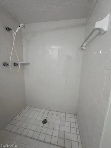 Full bath featuring tiled shower