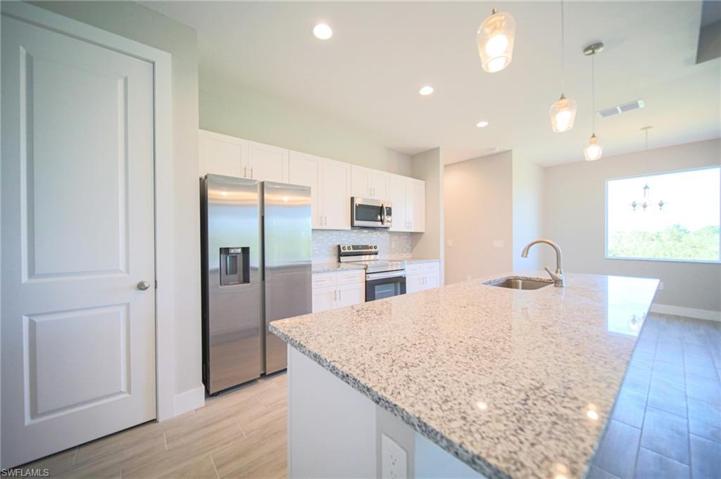 The Island Kitchen Has Granite Countertops, Tile Backsplash, Stainless Steel Appliances, White Shaker Soft Touch Cabinets And Drawers, And A Large Walk-In Pantry!
