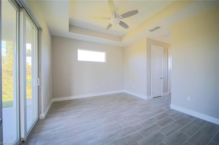 You Will Love This Oversized Master Bedroom With Tray Ceilings, Two Walk-In Closets, And A Double Slider That Leads Out To The Covered And Screened Lanai!