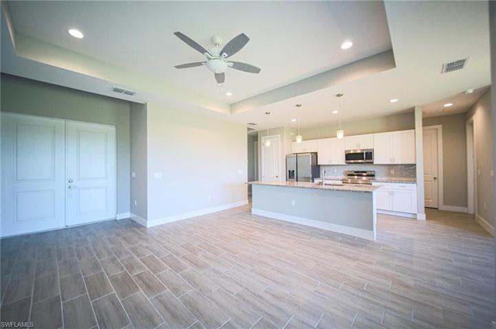 The Tiled Living Room Has Double Front Entry Doors And A Double Glass Slider Out To Covered Screened Lanai!