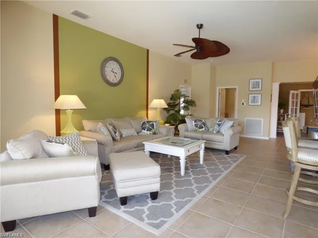 Tiled living room featuring ceiling fan