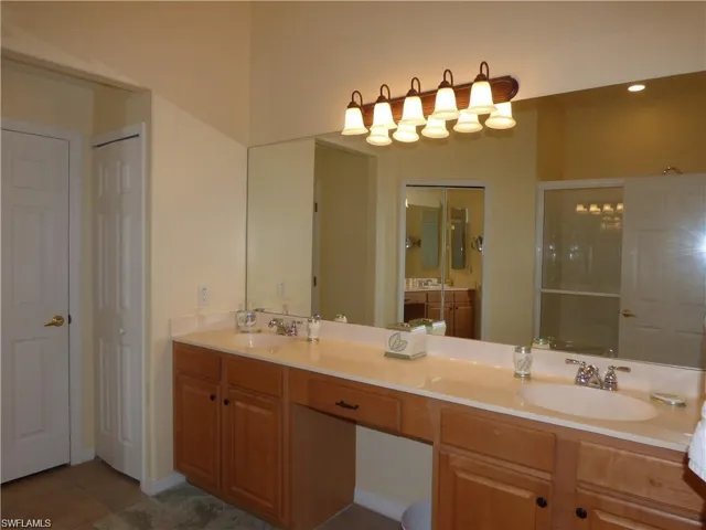 Bathroom featuring double sink vanity and tile patterned flooring