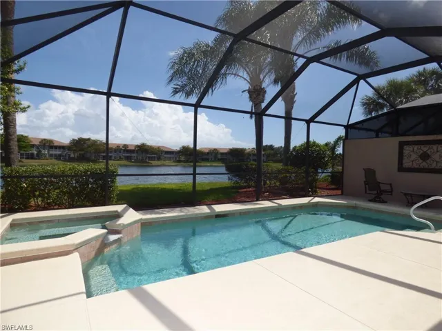 View of swimming pool featuring a patio area and a lanai