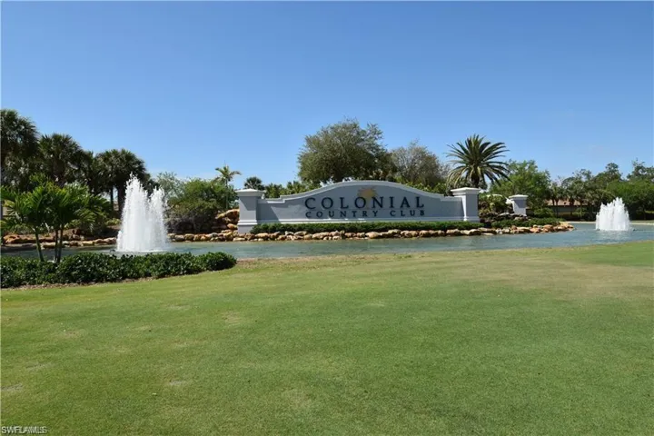 Community / neighborhood sign featuring a lawn