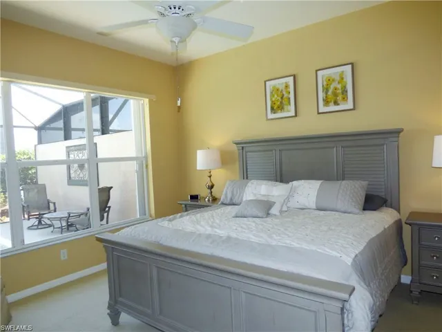 Bedroom featuring ceiling fan and carpet flooring