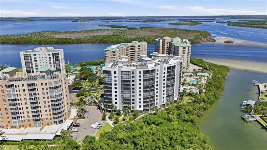 Bird's eye view of apartment complex and a large body of water - Virtually Edited Image