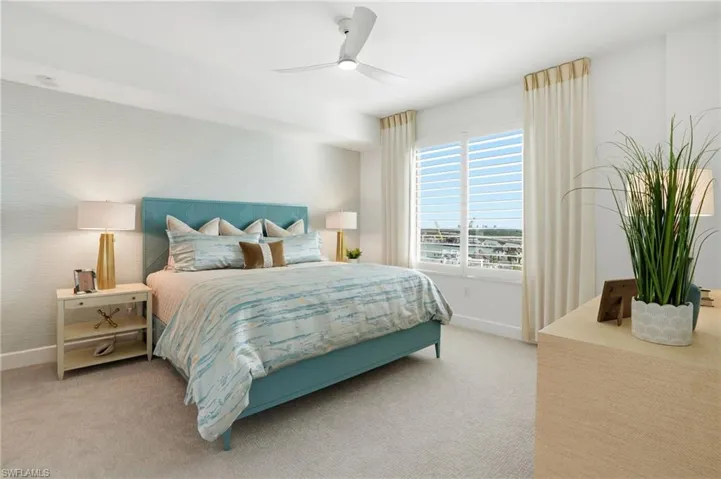 Bedroom featuring light carpet and ceiling fan - Virtually Edited Image