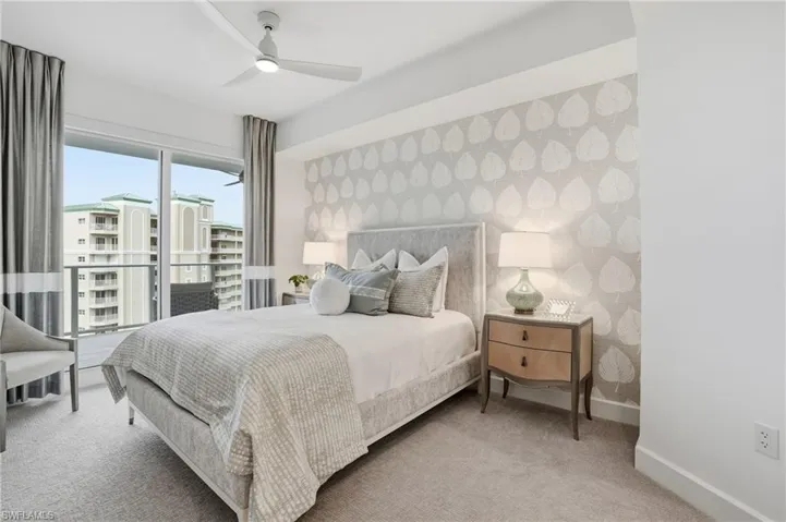Bedroom with carpet floors, ceiling fan, and wallpapered walls - Virtually Edited Image