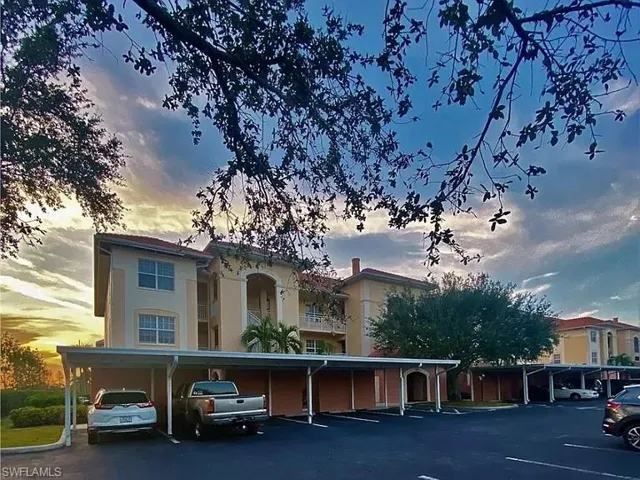 View of property featuring covered parking