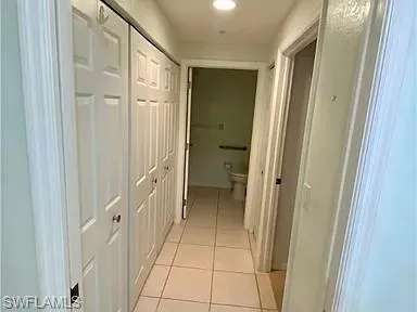Hallway featuring light tile patterned flooring