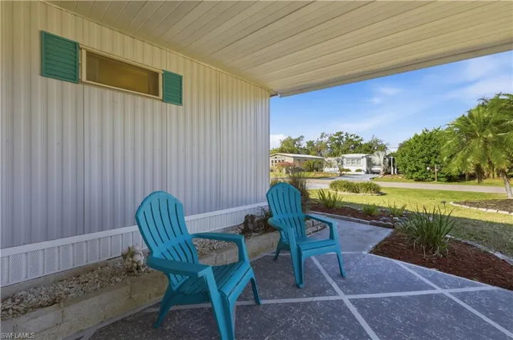 Covered porch with a lawn and a residential view