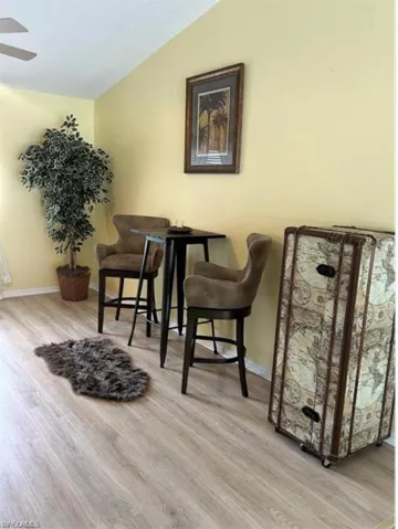 featuring light wood finished floors and vaulted ceiling