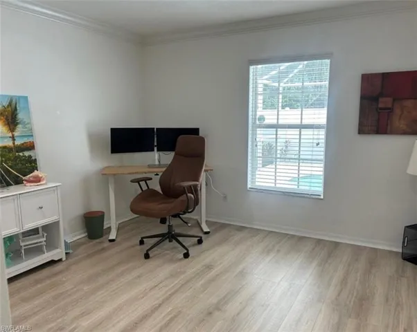 Office or bedroom  featuring crown molding and light wood-type flooring