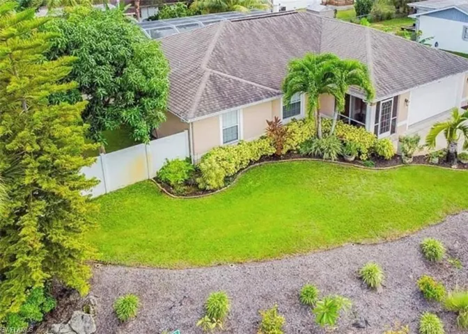 Aerial view of property and corner lot