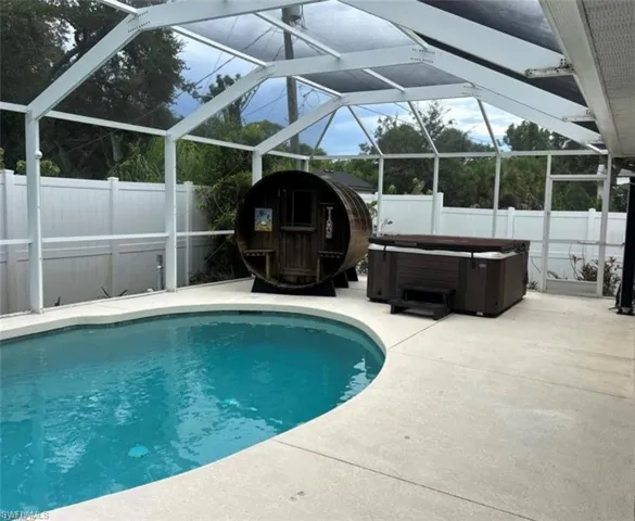 Enclosed lanai, fenced backyard, dry sauna, and hot tub