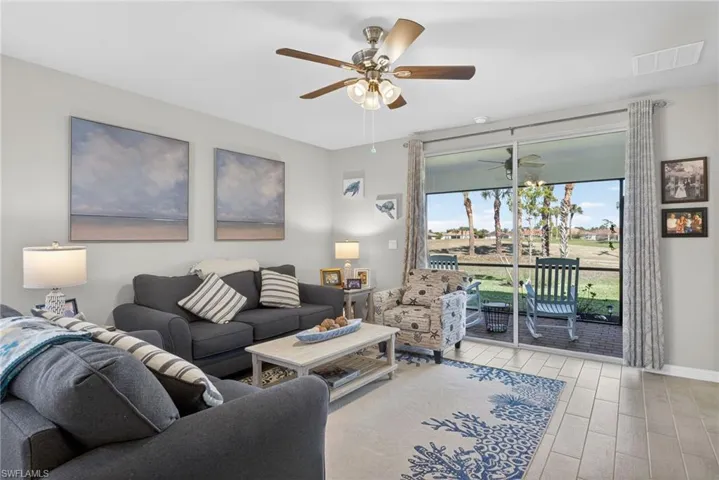 Living room featuring tile floors floors and ceiling fan