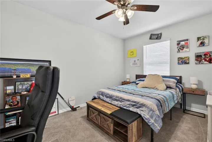 Bedroom featuring light colored carpet and a ceiling fan