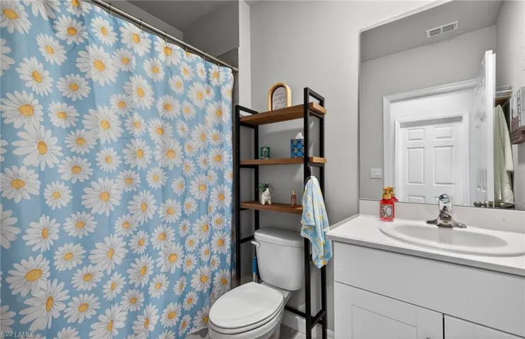 Full bath with a shower tub combo and vanity.