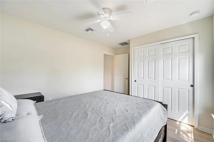 Bedroom with a ceiling fan, a closet, and light wood-style flooring