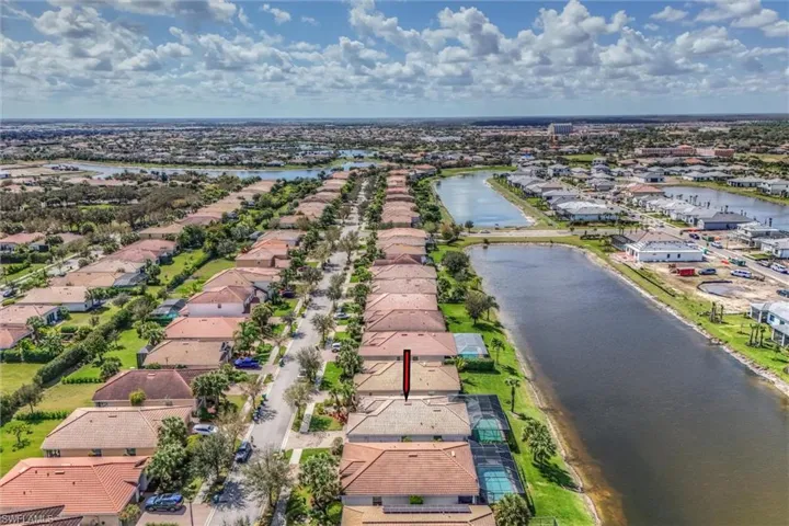 Aerial view of residential area featuring a large body of water