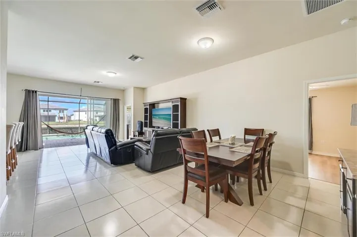 Dining room featuring light tile patterned floors and baseboards