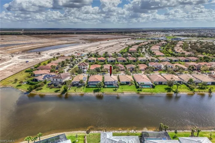Aerial view of residential area featuring a large body of water