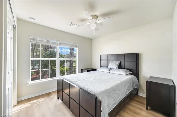 Bedroom with light wood-style floors and a ceiling fan