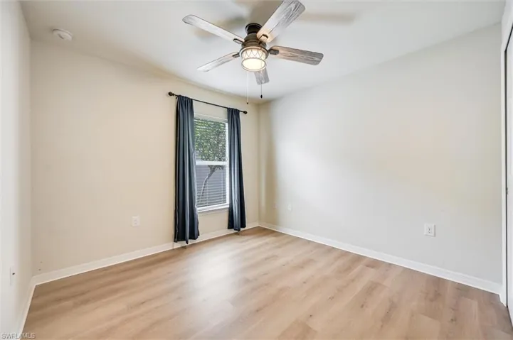 Unfurnished room with light wood-style flooring and ceiling fan