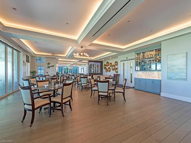 Dining area featuring coffered ceiling, hardwood / wood-style floors, and a notable chandelier