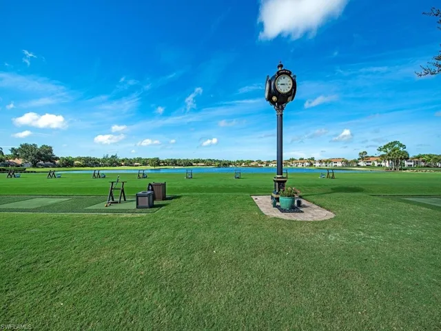 Surrounding community with a water view and a yard