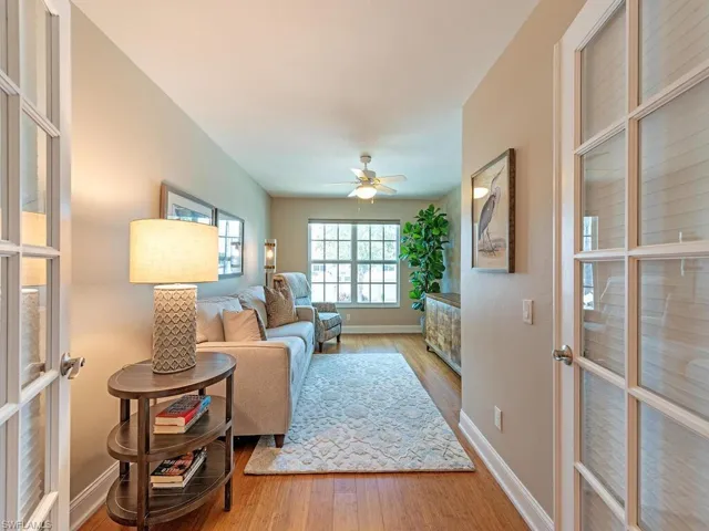 Living room with light wood-type flooring, french doors, and ceiling fan