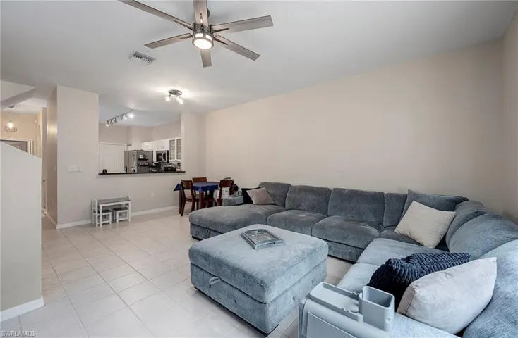 Tiled living room featuring ceiling fan