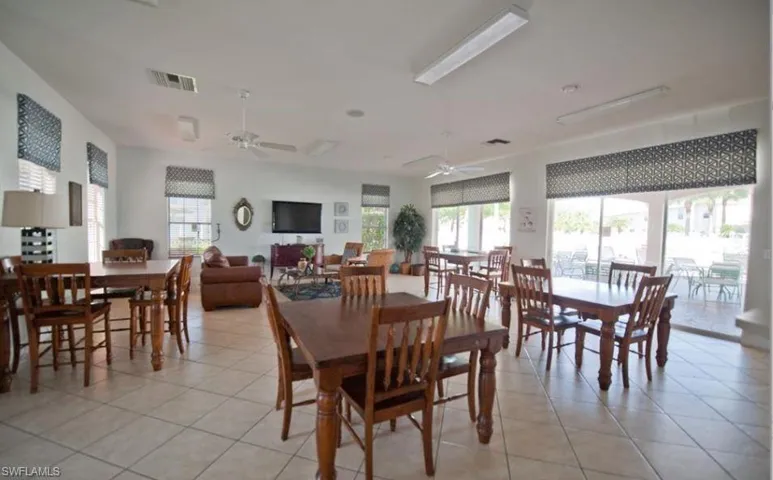 Dining room featuring light tile patterned floors and ceiling fan
