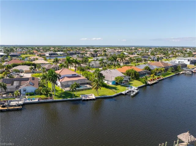 Aerial view of residential area featuring a large body of water