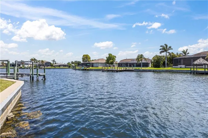 Dock with a residential view and a water view