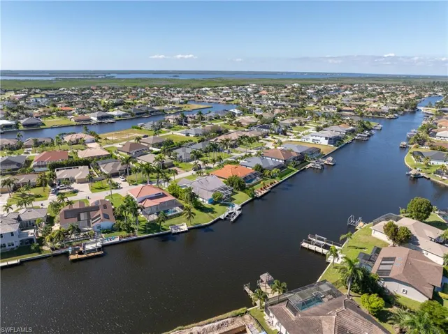 Aerial view of residential area featuring a nearby body of water