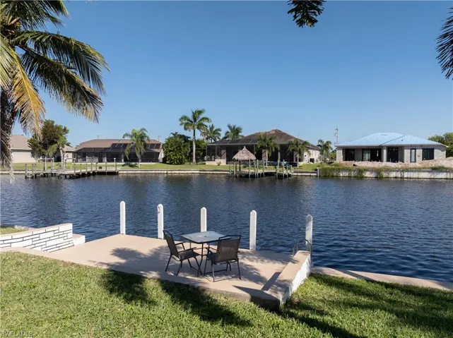 Dock area featuring a water view, a residential view, and a yard
