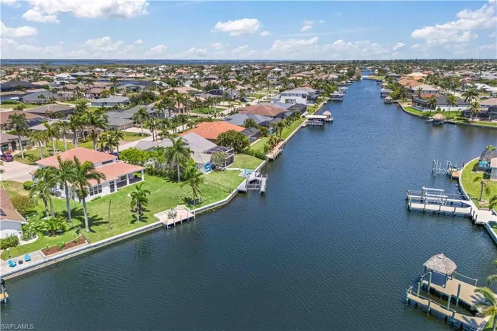 Aerial view of residential area featuring a nearby body of water