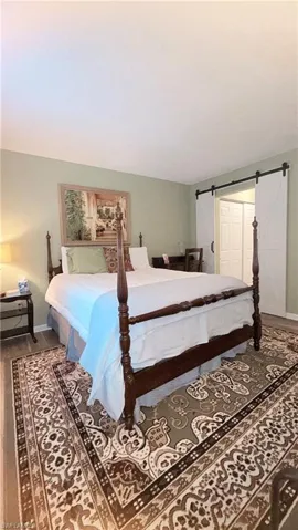 Bedroom featuring baseboards and wood finished floors