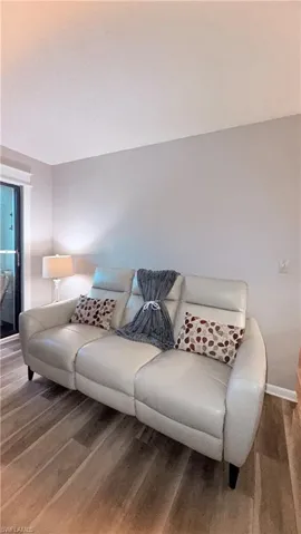 Living area featuring baseboards and wood finished floors