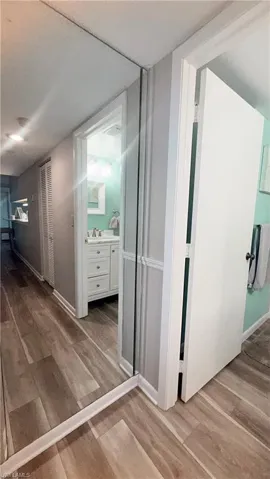 Hall featuring light wood-type flooring and baseboards