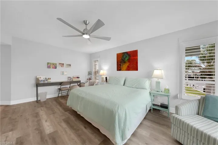 Bedroom featuring ceiling fan and light hardwood / wood-style flooring