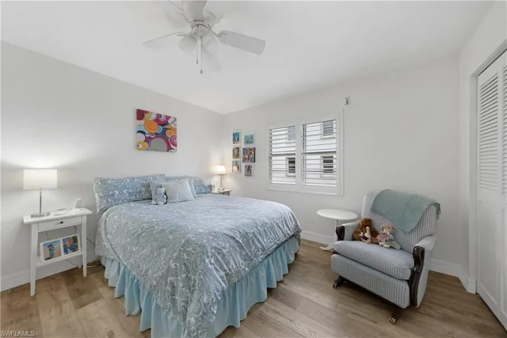 Bedroom with a closet, light hardwood / wood-style flooring, and ceiling fan