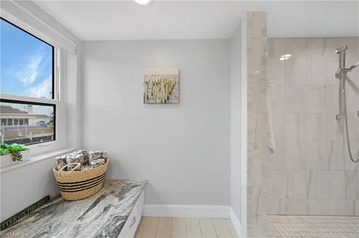 Bathroom featuring a tile shower and hardwood / wood-style flooring