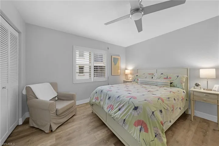 Bedroom with light wood-type flooring, a closet, and ceiling fan